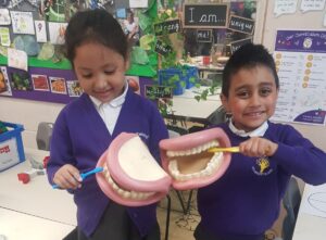 children pictured learning how to brush teeth properly