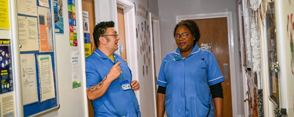 Staff chatting on a corridor