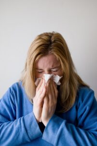 Woman blowing her nose
