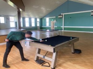 Photo of Trust staff member using pool table