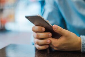 Image of man scrolling on phone