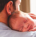 Photo of dad holding baby
