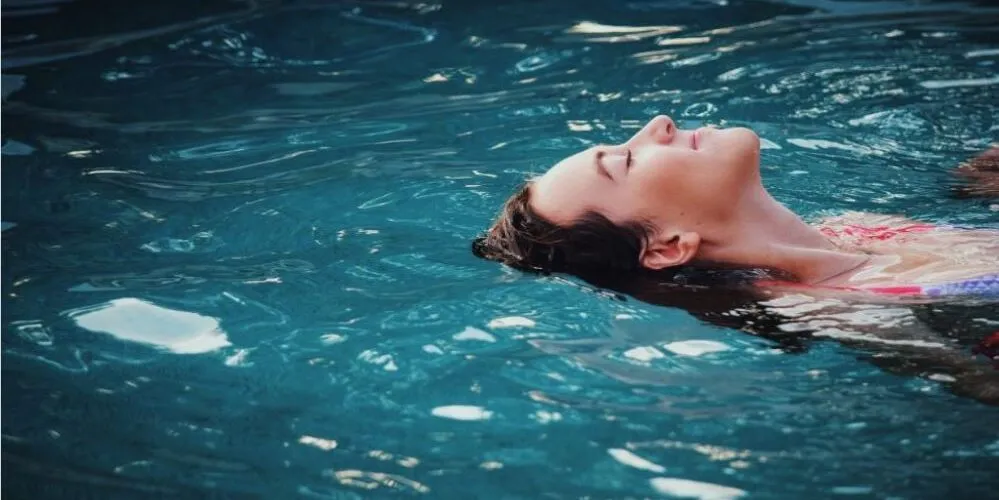 An image of a woman's head in a swimming pool