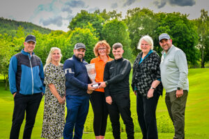 Photo of the winners holding trophy