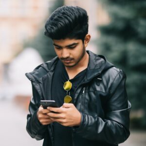 Photograph of young man using smartphone