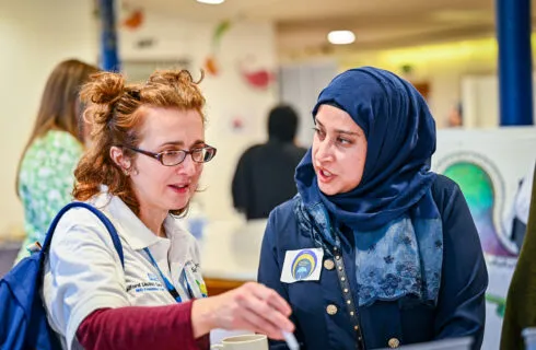 Image of two women talking to each other