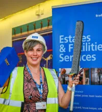 Image of a woman with a hard hat and tool box